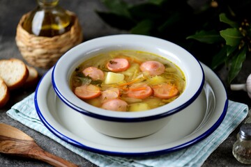 Cabbage soup with potatoes, onions, carrots and sausages.