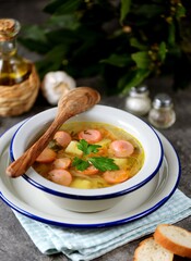 Cabbage soup with potatoes, onions, carrots and sausages.