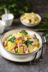 Salad with cod liver, potatoes, eggs, olives, onions and croutons.