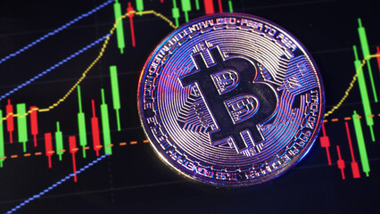 Close up bitcoin and digital stock market graph bar on black. Cryptocurrency. Bitcoin Stock Growth. Investing in virtual assets. Investment platform with charts and bitcoin coin. digital money. 