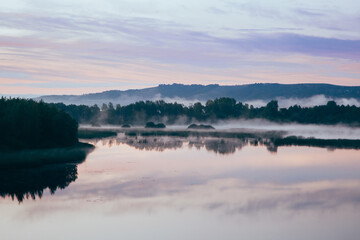 Fototapeta premium Beautiful morning landscape with fog over the river