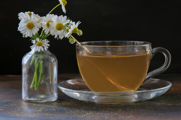 chamomile tea and flowers in a cup.