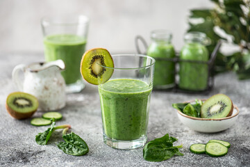 Healthy spinach, cucumber, kiwi, parsley smoothie with mineral water.