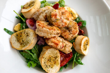 Salad with prawns, peppers, avocado, broccoli and arugula served from the restaurant menu