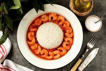 Stewed prawns in tomato sauce with rice.