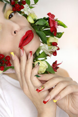 Multi-colored French manicure and makeup on the girl with red, green and yellow color.