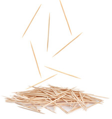 Wooden toothpicks falling into pile on white background - obrazy, fototapety, plakaty