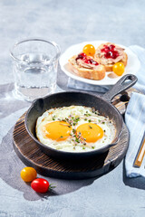 Fried eggs in cast-iron skillets. Sunny morning breakfast concept