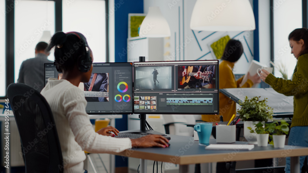 Poster black videographer putting on headset editing movie using post production software working in creati
