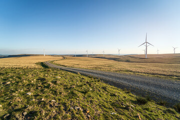 Road through Mynydd y Betws wind farm, Swansea, Carmarthenshire, South Wales, UK. Wind power,...