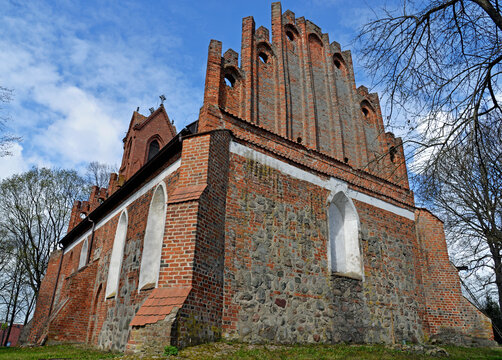 Built at the end of the 14th century in the Gothic style of red brick and stones, St. John's Catholic Church in the village of Czerniki in Masuria, Poland. The photos show a general view of the temple