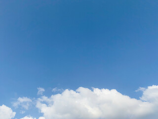 Clean blue sky and white clouds sky background with space for decoration. And used to make wallpaper or bring to work in graphic design.