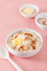 rice pudding with butter cinnamon. french riz au lait, norwegian risgrot, traditional breakfast dessert