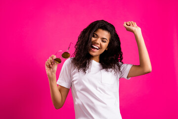 Portrait of attractive carefree cheerful girl enjoying having fun dancing isolated over vivid pink...