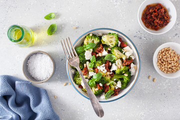 healthy broccoli salad with feta cheese sun dried tomatoes pine nuts.. vegetarian low carb keto diet