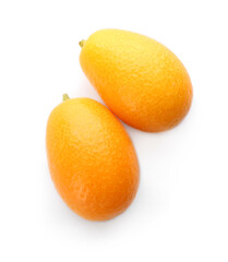 Two fresh ripe kumquats on white background, top view