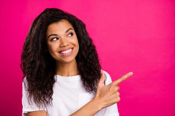 Portrait of attractive cheerful girl demonstrating copy space like follow subscribe isolated over...