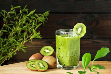 A glass of green smoothie made from kiwi fruit. Home cooking, vegetarian diet