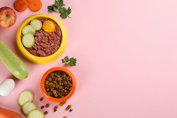 Pet food and natural ingredients on pink background, flat lay. Space for text