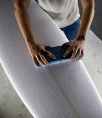 shaper modeling a new surf board