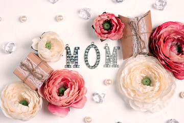 Festive white background with peony flowers, gift and  jewelry word mom.