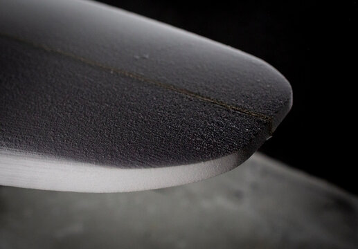 shaper modeling a new surf board