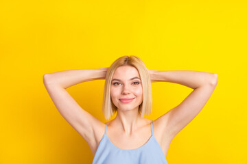 Fototapeta premium Photo of positive nice blond short hair lady rest wear blue top isolated on vivid yellow color background