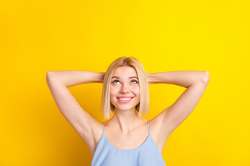 Photo of cheerful sweet blond short hair lady look empty space wear blue top isolated on vivid...