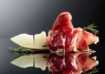 Prosciutto with melon and rosemary.