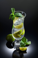 Mojito cocktail with ice, lime, and mint.