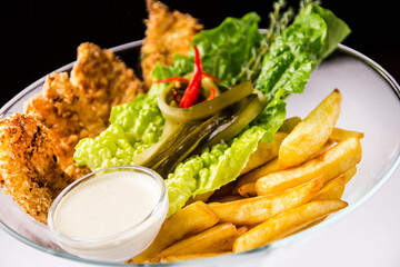 Chicken tenderloin with French fries and lettuce