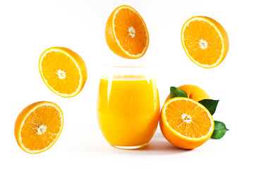 Glass of fresh orange juice with fruits cut in half and sliced with green leaf isolated on white background, clipping path