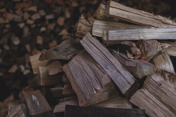 Winter preparation. Stacking Firewood. Pile of firewood loggs. Firewood background.