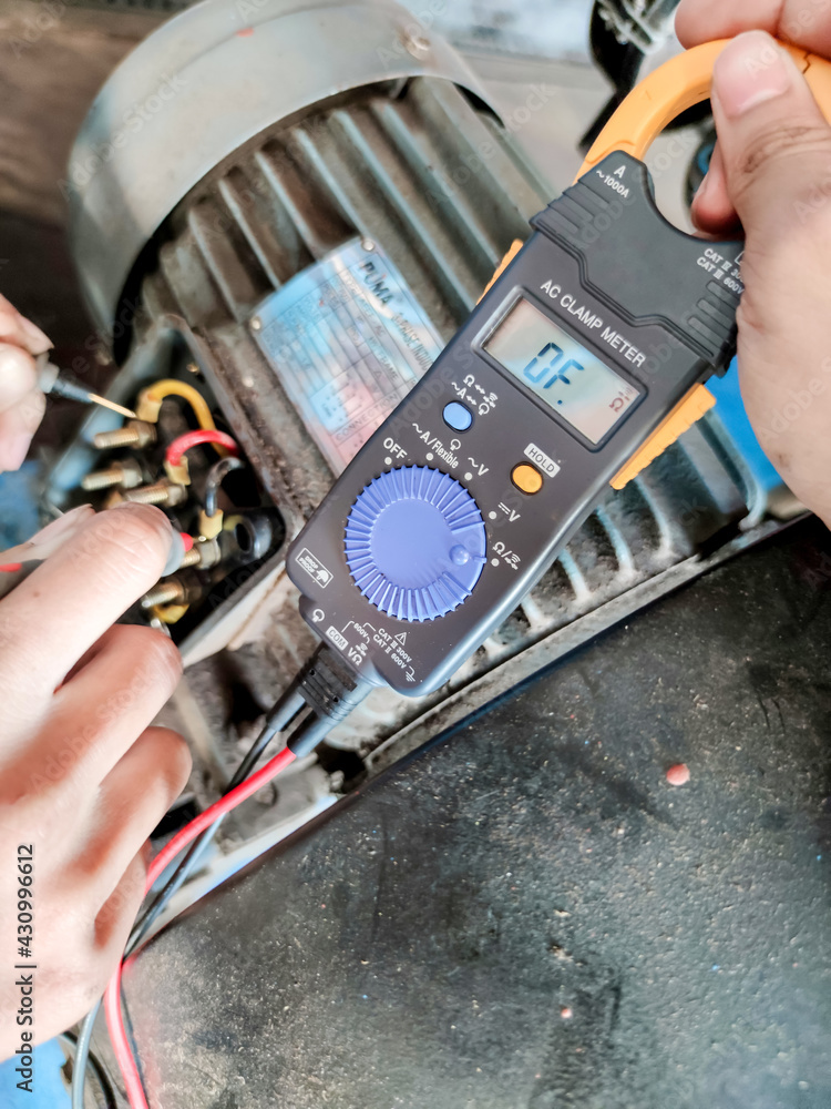 Wall mural checking and measuring the operation of an electric control motor with a meter in an industrial plan