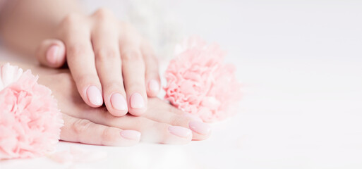 Banner manicure beautiful stylish trendy woman pink nails with flower on white background, top view