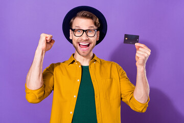 Photo of young guy happy positive smile rejoice victory success cold credit card isolated over...