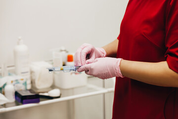 Cosmetologist with syringe and ampule with filler, closeup