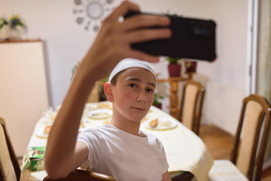 A Muslim Boy Taking A Selfie While Having An Iftar During Ramadan