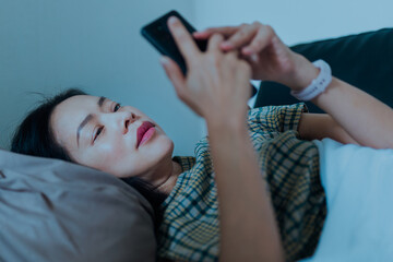 Woman lying on couch using mobile phone.