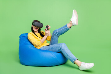 Full length body size photo of woman in beanbag playing video game in virtual reality glasses...