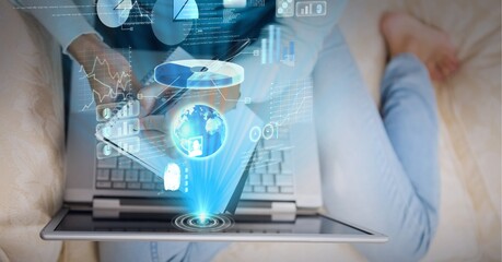 Composition of screen with data processing over woman sitting on sofa using laptop