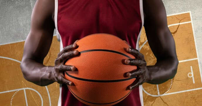 Composition of basketball player holding basketball over basketball court cracked distressed surface