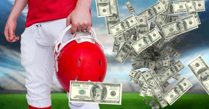 Composition of american dollar bills over midsection of american football player in sports stadium