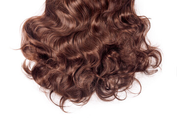 Brown hair texture. Wavy long curly light brown hair close up isolated on white. Hair extensions,...