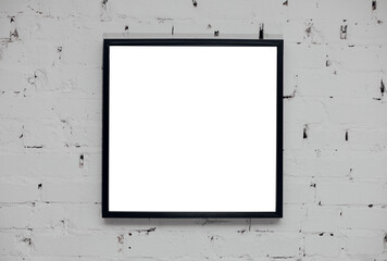 Blank picture frame at the brick wall