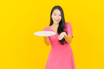 Portrait beautiful young asian woman smile with empty plate dish