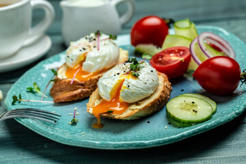 Sandwich with Poached Egg. Bread Toast sliced egg and fresh vegetable salad with cup of coffee for healthy breakfast or snack