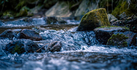 Close up of a river flowing over a stone