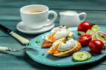 Sandwich with Poached Egg. Bread Toast sliced egg and fresh vegetable salad with cup of coffee for healthy breakfast or snack