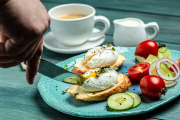 Sandwich with Poached Egg. Bread Toast sliced egg and fresh vegetable salad with cup of coffee for healthy breakfast or snack